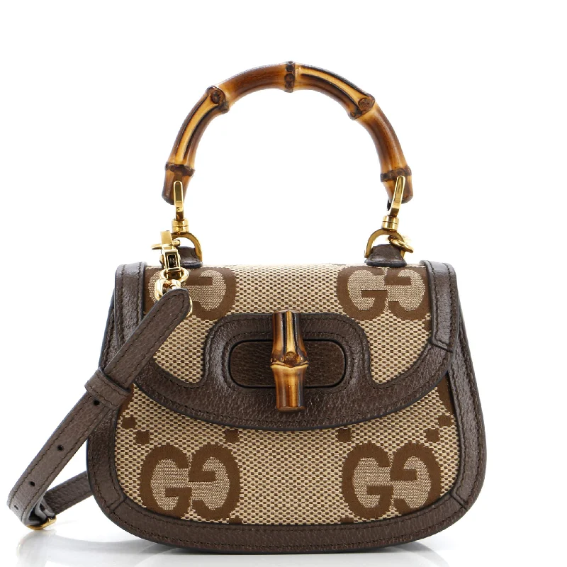 Women Gucci Sylvie bags featuring the signature web stripeBamboo 1947 Top Handle Bag Jumbo GG Canvas Mini